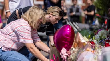 People lay flowers near the scene in Hart Street, Southport, where three children died and eight were injured in a "ferocious" knife attack during a Taylor Swift event at a dance school on Monday.
