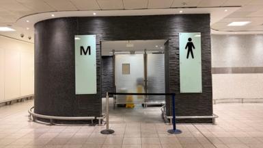 The entrance of a men's toilet which is blocked off.