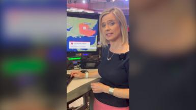BBC Weather presenter Sarah Keith-Lucas next to computer screen showing extreme heat map