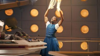 Ncuti Gatwa as the Doctor regenerating. He is holding his hands up in the air and looking at them as light comes out from them and shooting upwards.
