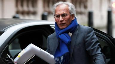 Samir Shah in a suit and bright blue scarf arriving for the committee hearing