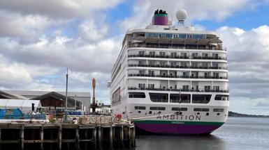 MS Ambition cruise ship sits docked in a body of water