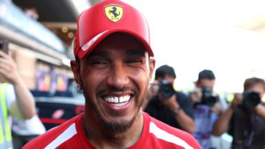 Lewis Hamilton smiles while celebrating his victory for Ferrari in the Barcelona-Catalunya Grand Prix