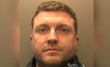 Close up custody image of Robert. He has short light brown hair. Robert is wearing a black fleece. 