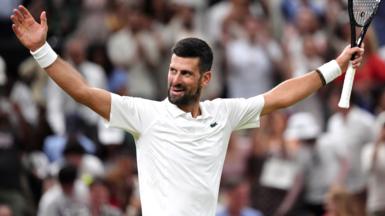 Novak Djokovic raises his arm in celebration