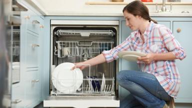 Woman stacking dishwasher