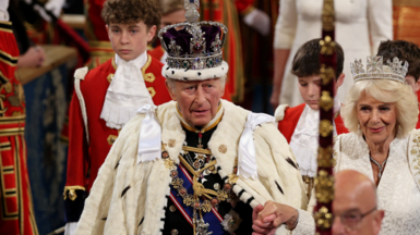 King Charles and Queen Camilla walk through the Royal Gallery during the State Opening of Parliament 