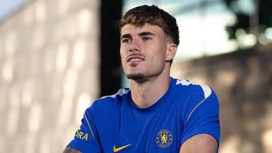 Pep Chavarria looks past the camera while wearing a Chelsea shirt