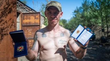 Andrii Andriichuk, a career criminal, shows off his ‘Hero of Ukraine’ medal; the country’s highest honour