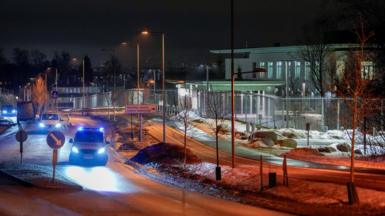 Police vehicles are parked outside the US embassy in Oslo