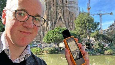 James Gallagher holding a sound meter 