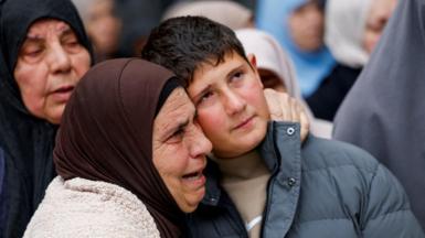 Khaled Bani Odeh is embraced by a woman during the funeral for his parents and two of his brothers in Tammun, in the Israeli-occupied West Bank (15 March 2026)