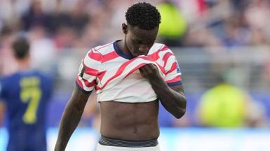Folarin Balogun covers his face with his shirt after being sent off