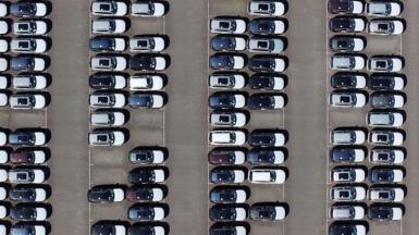 An aerial view of whit and black imported new cars on the quayside of Alexandra Dock at Grimsby Port.