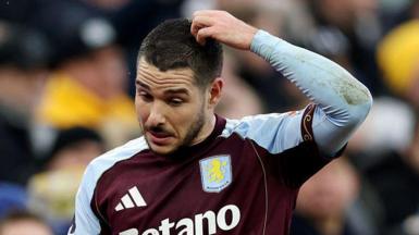 Emi Buendia scratches his head.