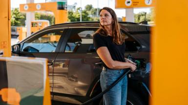 Woman filling up her car with petrol