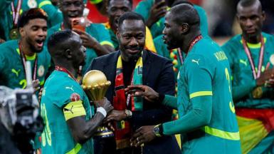Pape Thiaw and the Senegal players celebrate with the trophy after winning the Africa Cup of Nations