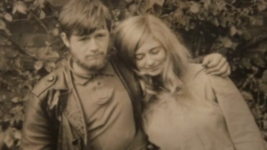 A sepia image of a man with a beard and a woman with long hair 