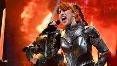 Chappell Roan sings while performing in an armour costume against a fiery backdrop at 2024 MTV Video Music Awards at UBS Arena on September 11, 2024 in Elmont, New York