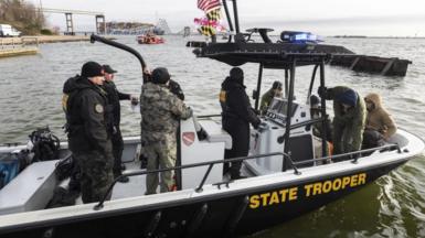 Rescue personnel on a boat in Baltimore