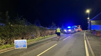 Police on the road after a rail crash was reported in Powys