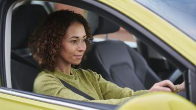 Close up view of a woman driving a car