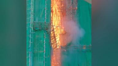 Fire in Wang Cheong House surrounded by green building covers