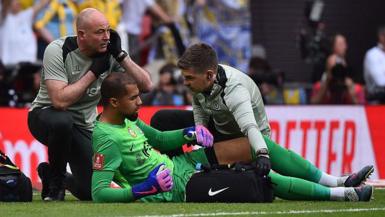 Robert Sanchez receives treatment for an apparent injury during the FA Cup semi-final between Chelsea and Leeds United at Wembley Stadium