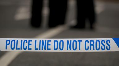White and blue police tape, reading: "Police line do not cross".