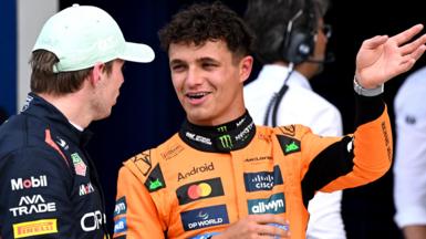 Lando Norris smiles and gestures with his left hand while talking to Max Verstappen after Miami Grand Prix qualifying