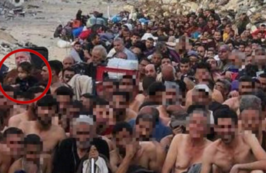 A zoomed-in image shows a group of Gazan men, in Israeli detention and sitting outdoors against the backdrop of a destroyed building. A little girl is there, circled in red by the 91ȱ in this image, for clarity.