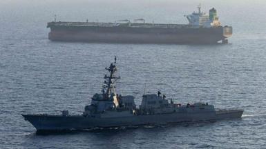 A US military ship is seen in the foreground in the Arabian Sea in April, while another ship is seen in the background.