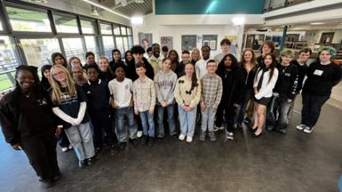 A group of children posing for a photo in a youth club.