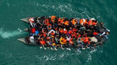 An inflatable dinghy carrying migrants makes its way towards England in the English Channel, Britain