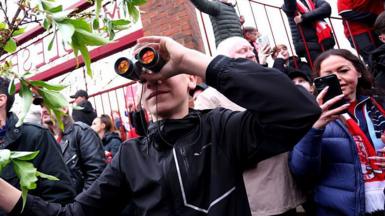 A fan is seen using binoculars outside the stadium prior to the Championship play-off semi-final match between Middlesbrough and Southampton at Riverside Stadium