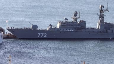The Russian Neustrashimy frigate - a long, grey vessel with the number 772 printed on the side in white - in the water.