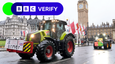 A tractor passes Parliament in London with a sign on front of it saying 'stuck farmer', with another tractor behind it driving down the street, and Big Ben in the background. Picture date 19 November.