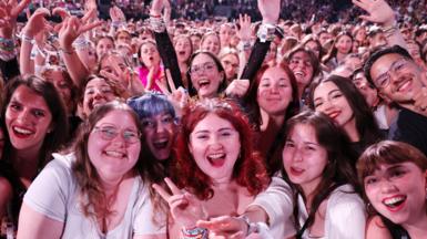 Fans watch Taylor Swift perform onstage during "Taylor Swift | The Eras Tour" at La Defense on 10 May, 2024 in Paris, France. 