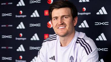 Harry Maguire smiling in a Manchester United news conference