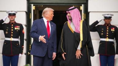 A file picture of Saudi Crown Prince Mohammed bin Salman and Donald Trump standing outside  White House, behind them are two men in uniform saluting 