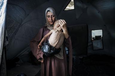 Gaza mother cradling baby