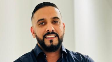 A head and shoulders shot of a smiling man