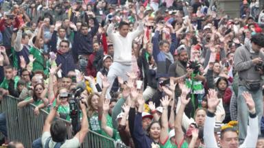 Crowd with hands up doing celebratory wave