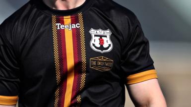 Man wearing black football shirt with Trearddur Bay logo