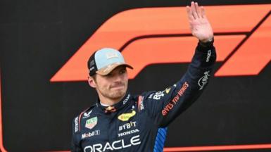 Max Verstappen waves in celebration after taking pole for the United States Grand Prix sprint race