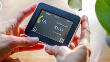Someone holding a smart meter