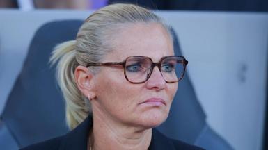 Sarina Wiegman looks forward with a fixed expression