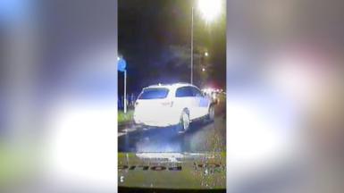 View from a police car as it follows a woman suspected of drink-driving