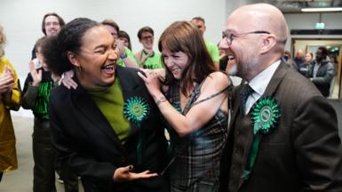 Iris Duane of the Green Party of Scotland celebrates with other Green Party hopefuls while ballots are still being counted in Glasgow