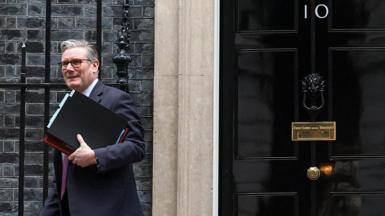 Sir Keir Starmer walking away from the door at to 10 Downing Street with files under his arm